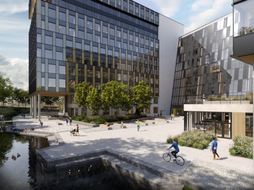 Digital gjengivelse av Construction City, med to store moderne bygninger med glassfasader, beplantede områder, folk som går og sykler, og en vannflate i forgrunnen som speiler scenen.