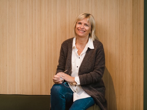Seated half body portrait of employee Astrid Eriksen