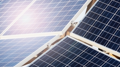 Close-up of solar panels arranged in a grid, reflecting sunlight.